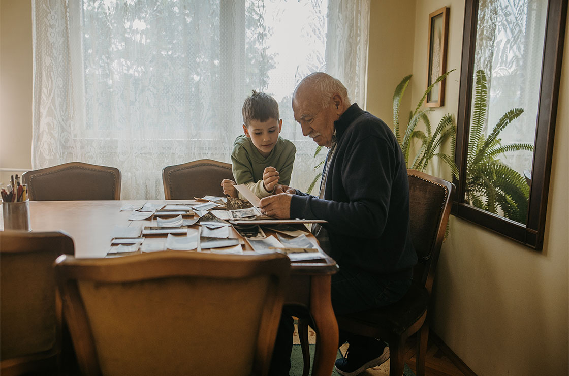 Grandfather showing pictures to grandson